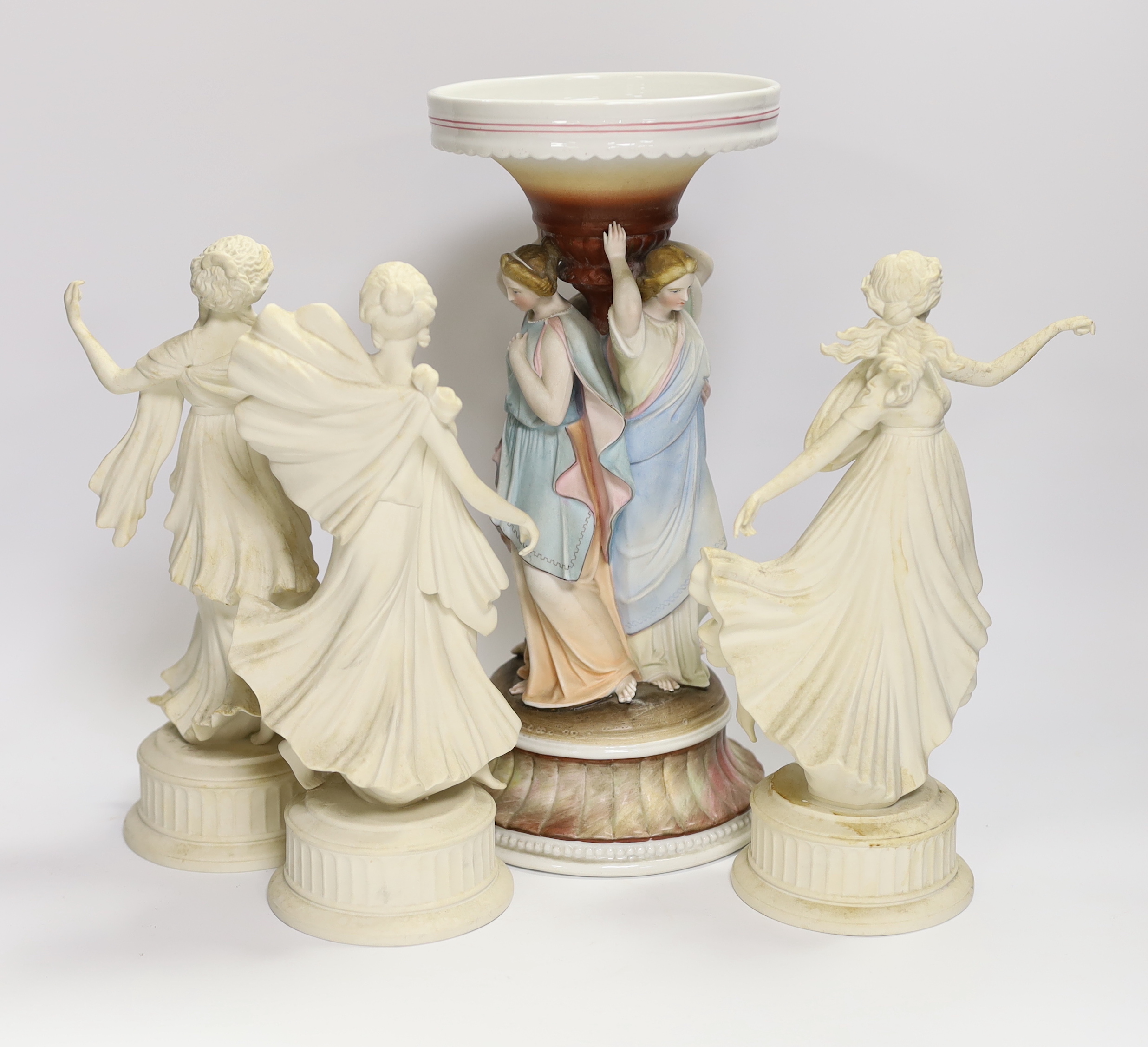 Three Wedgwood Dancing Hours figurines and a 19th century porcelain three graces centrepiece, largest 30cm high